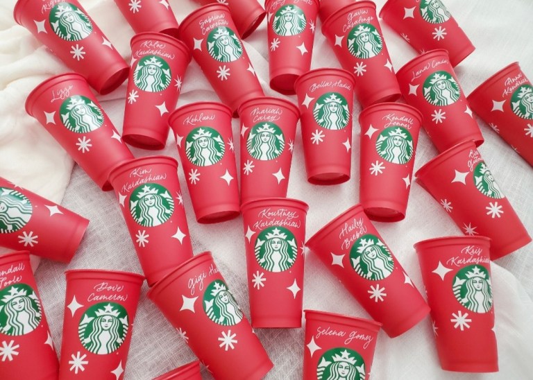 personalized calligraphy names on starbucks red cup holiday brand activation celebrities 768x548