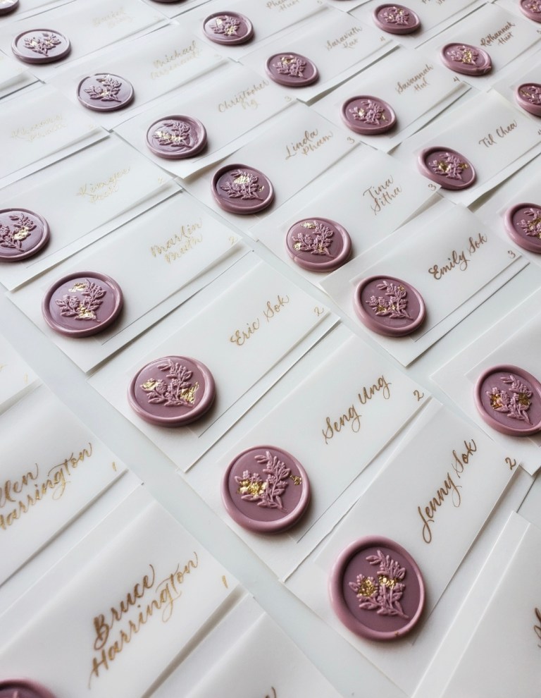 wedding place cards escort cards vellum paper with gold ink and wax seal with gold leaf flakes 768x990