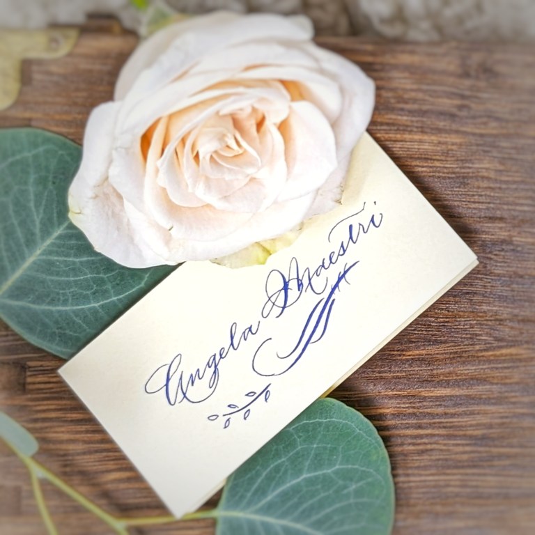 Houston Texas calligraphy and engraving live events The Beaux Arts periwinkle ink flourished place card close up 768x768