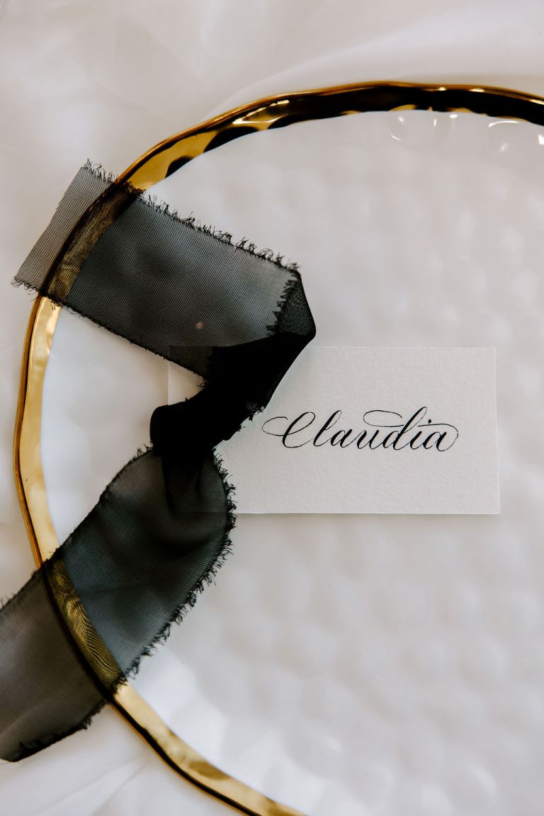 The MB Studio Tricities WA Calligrapher Engraver Live Event Artist Placecard Black Ink White Card Gold and White Plate Escort Card Hand Lettered 768x1152